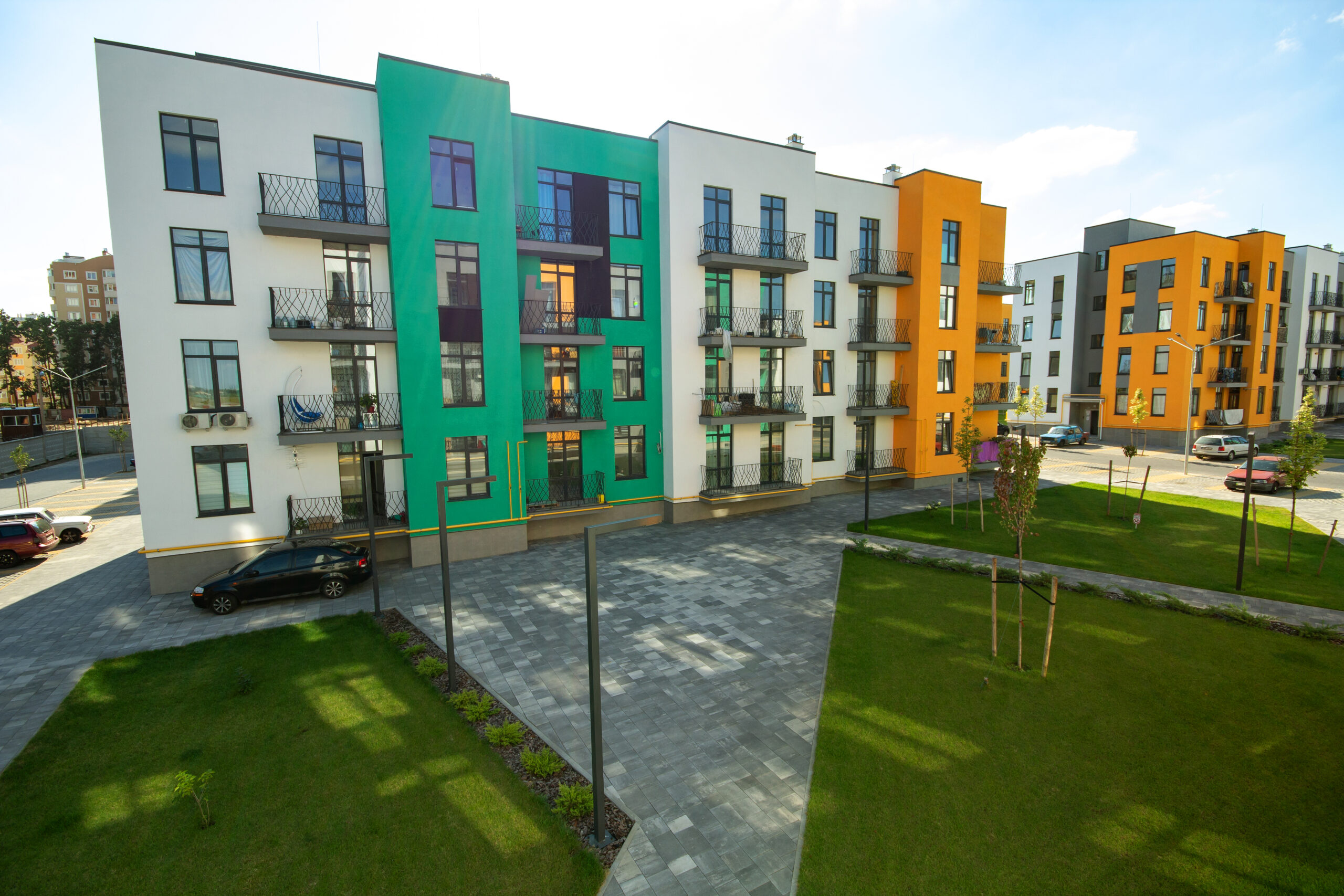 Yard between residential apartment buildings with green grass la Yard between residential apartment buildings with green grass lawns and modern flat housing. Real estate development.